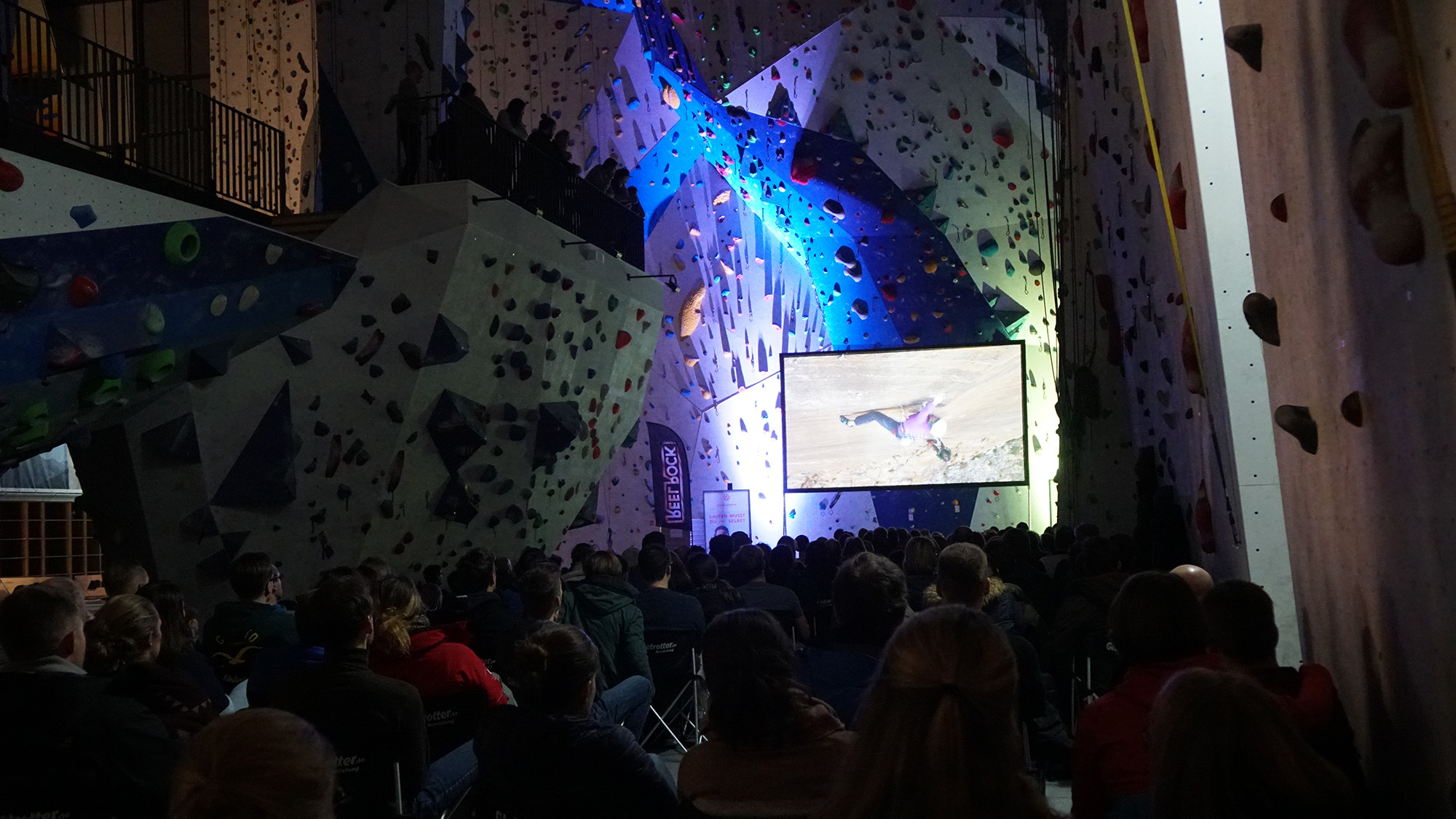 Climbing hall with set-up screen and large audience